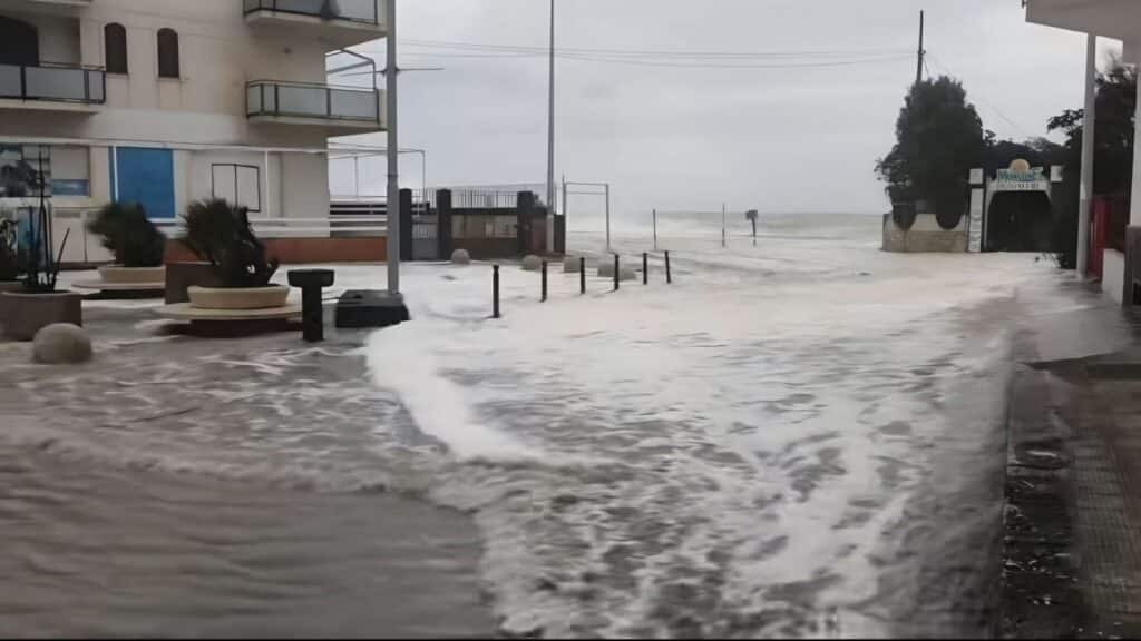Storm waves flood street.