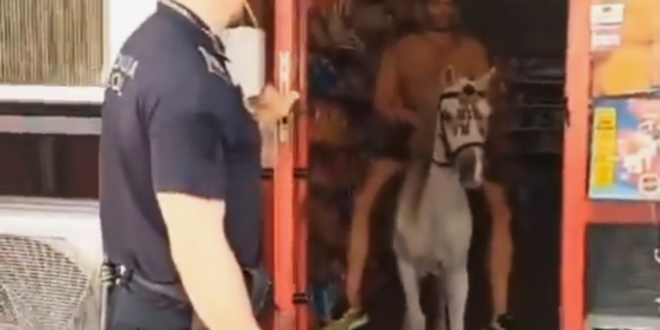 Watch: Bizarre moment a topless man on a horse exits his local corner shop in Spain