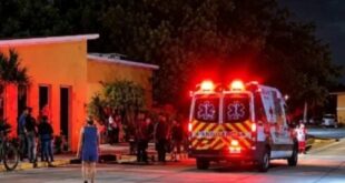 An ambulance outside an orange building