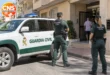 Guardia Civil officers in Torrevieja beside a patrol car