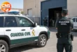 Guardia Civil officer outside a warehouse in Huércal