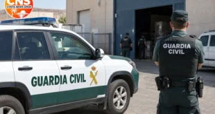 Guardia Civil officer outside a warehouse in Huércal