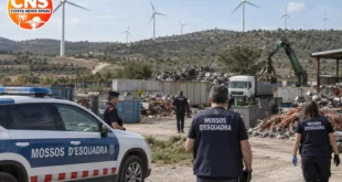 Wind turbines in rural Catalonia near a recycling yard