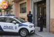 Policía Nacional officers outside a residential building in Gandia