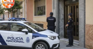 Policía Nacional officers outside a residential building in Gandia